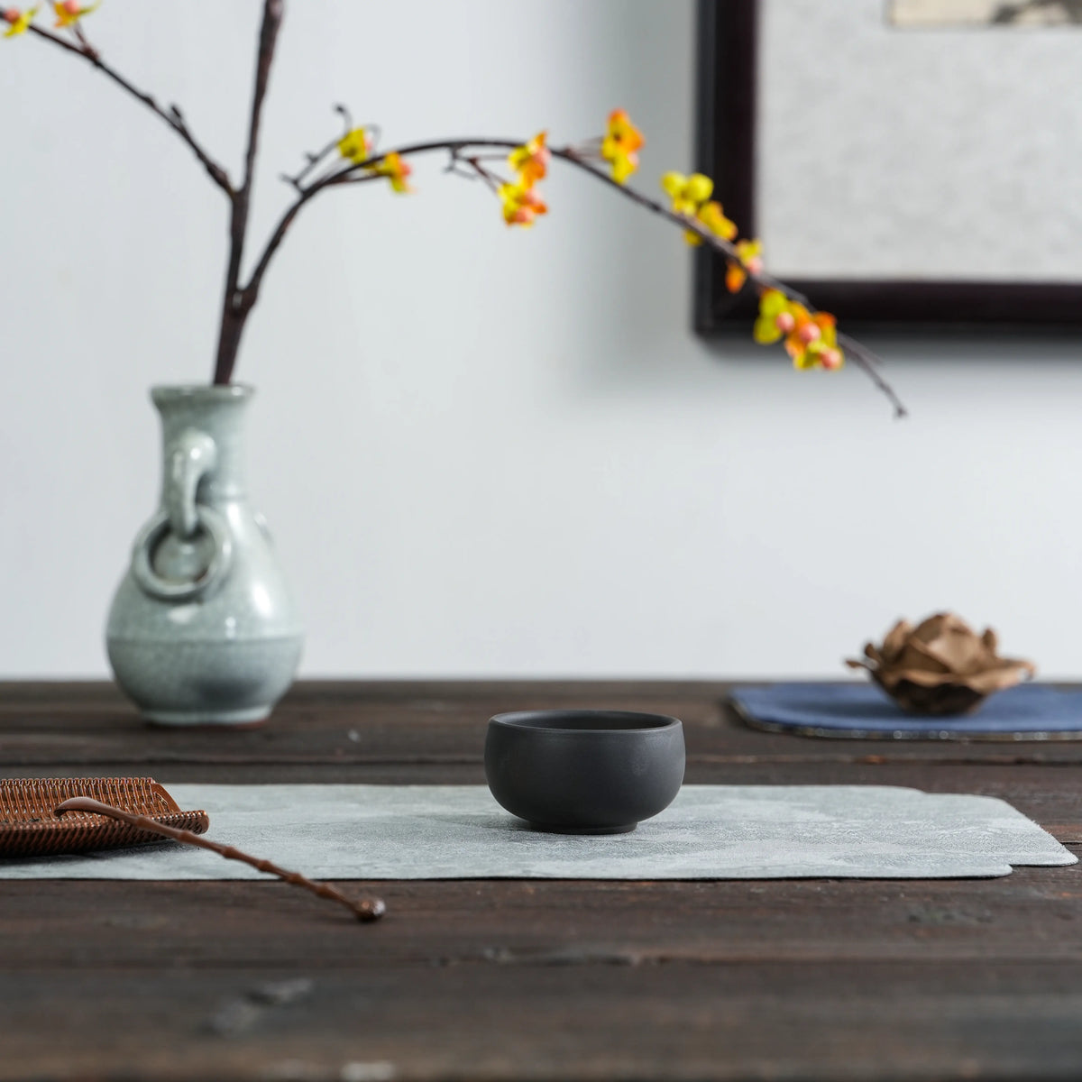 Handmade Jianshui black clay tea cup in a tea setting