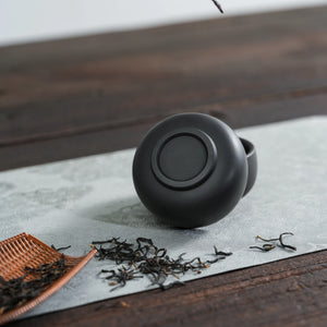 Bottom view of handmade Jianshui black clay tea cup
