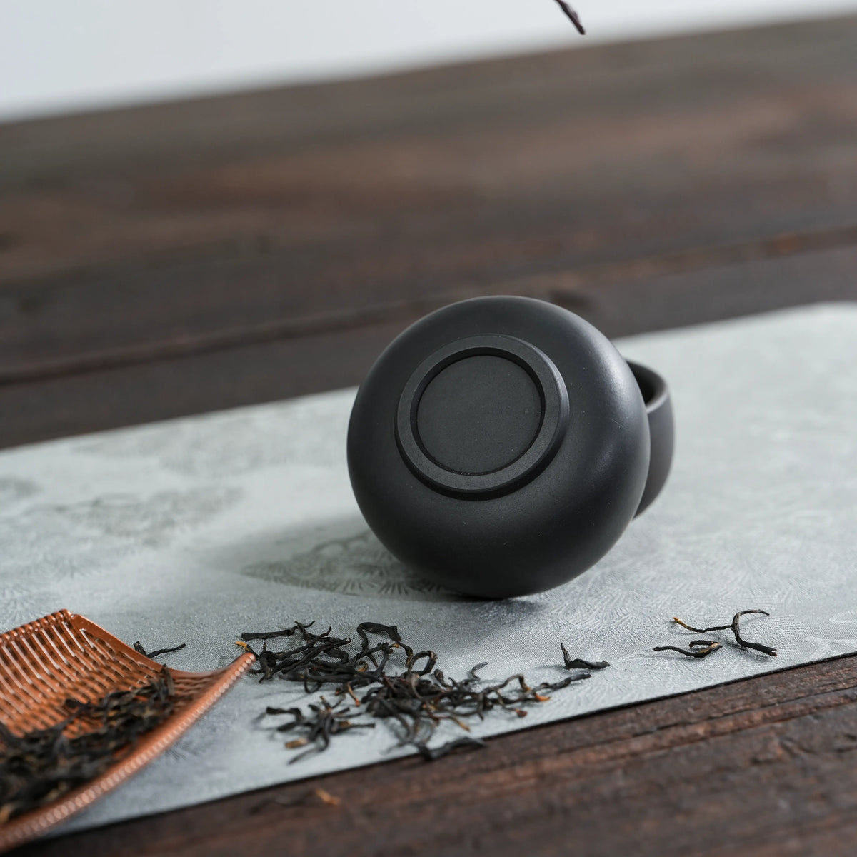 Bottom view of handmade Jianshui black clay tea cup