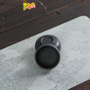 Side view of handmade Jianshui black clay tea cup