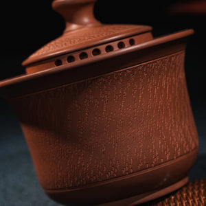 Close view of hand-worked chattering texture on Jianshui red clay teapot