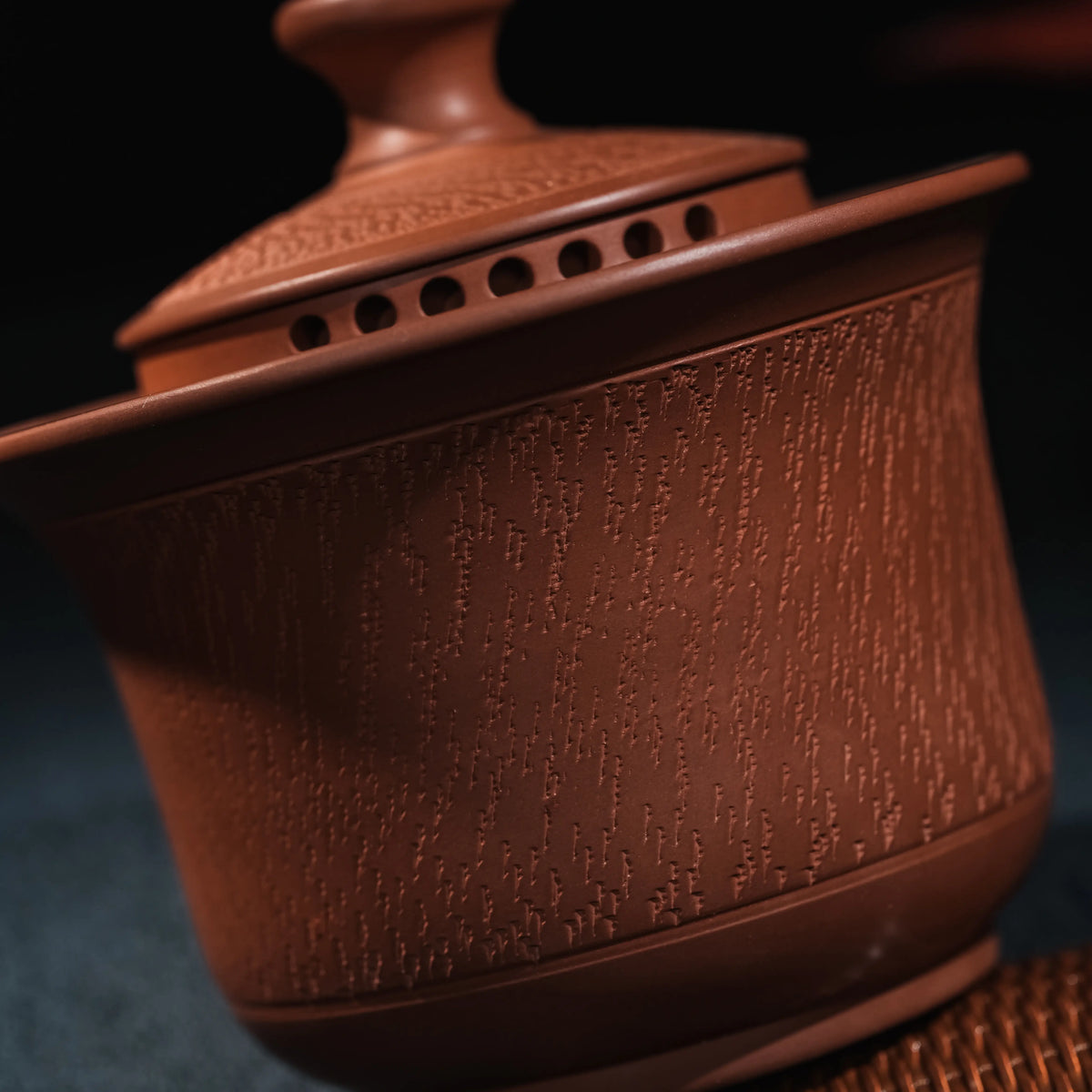 Close view of hand-worked chattering texture on Jianshui red clay teapot