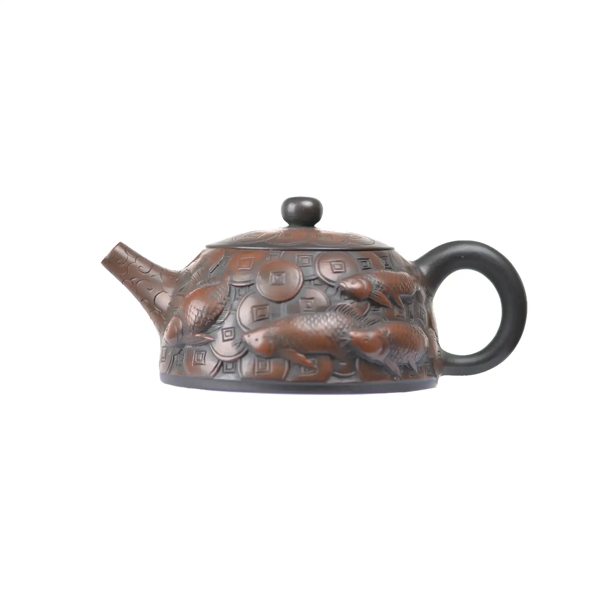Left side view of PorSva No.35 clay teapot highlighting detailed coin and fish carving motif