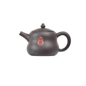 Left side view of PorSva No.48 gourd-shaped Jianshui clay teapot featuring carved Chinese calligraphy with red seal stamp