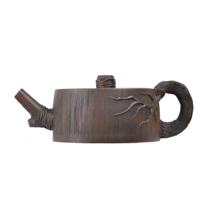 Left side view of PorSva No.53 root-style clay teapot showing sculptural tree root handle design