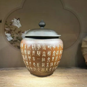 Unglazed clay tea jar with Yin-carved and Yang-filled decorative detailing