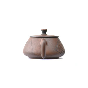 Back view of handcrafted clay teapot No.24 with antique bronze finish and relief detail