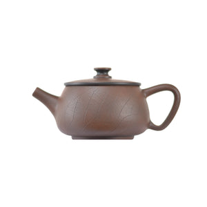 Side view of clay teapot No.10 with Bodhi pattern carving and traditional form