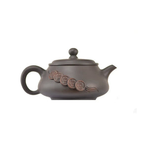 Side view of clay teapot No.15 showing raised coin relief design