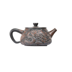 Opposite side detail of clay teapot No.32 highlighting intricate dragon and phoenix carving craftsmanship