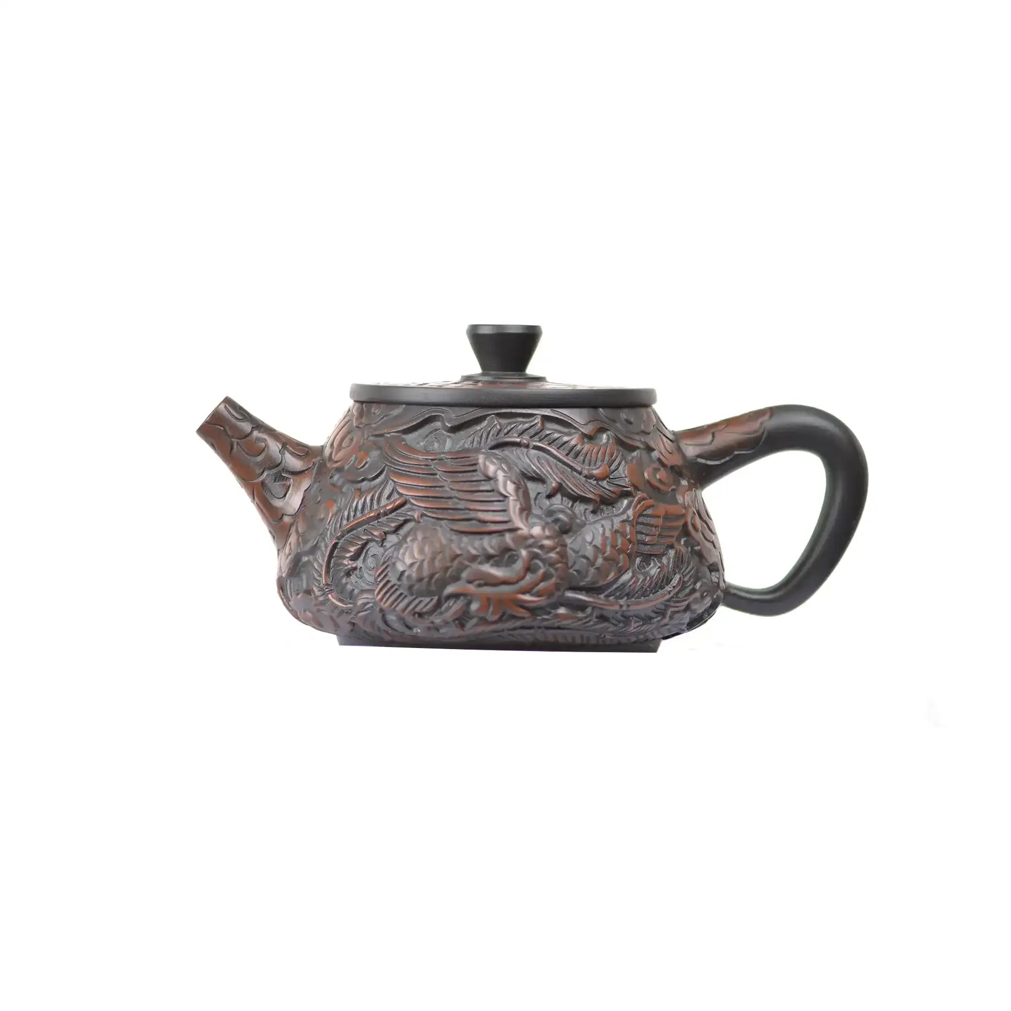 Side view of handcrafted Jianshui Zitao Xishi teapot No.32 highlighting intricate dragon and phoenix carving craftsmanship