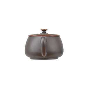 Back view of handcrafted clay teapot with clean uncarved design