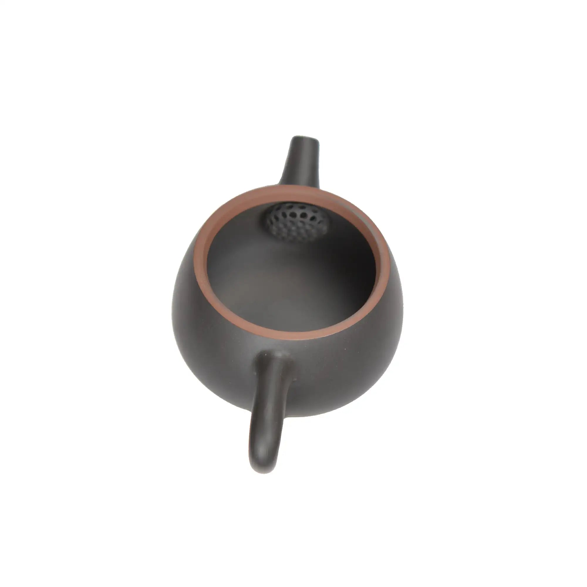Top-down interior view of a black handemade clay teapot showing built-in filter holes near the spout.
