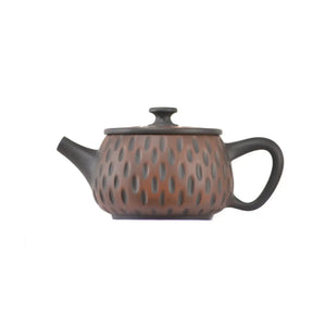 Side view of clay teapot No.13 showing meteor pattern detailing and traditional form