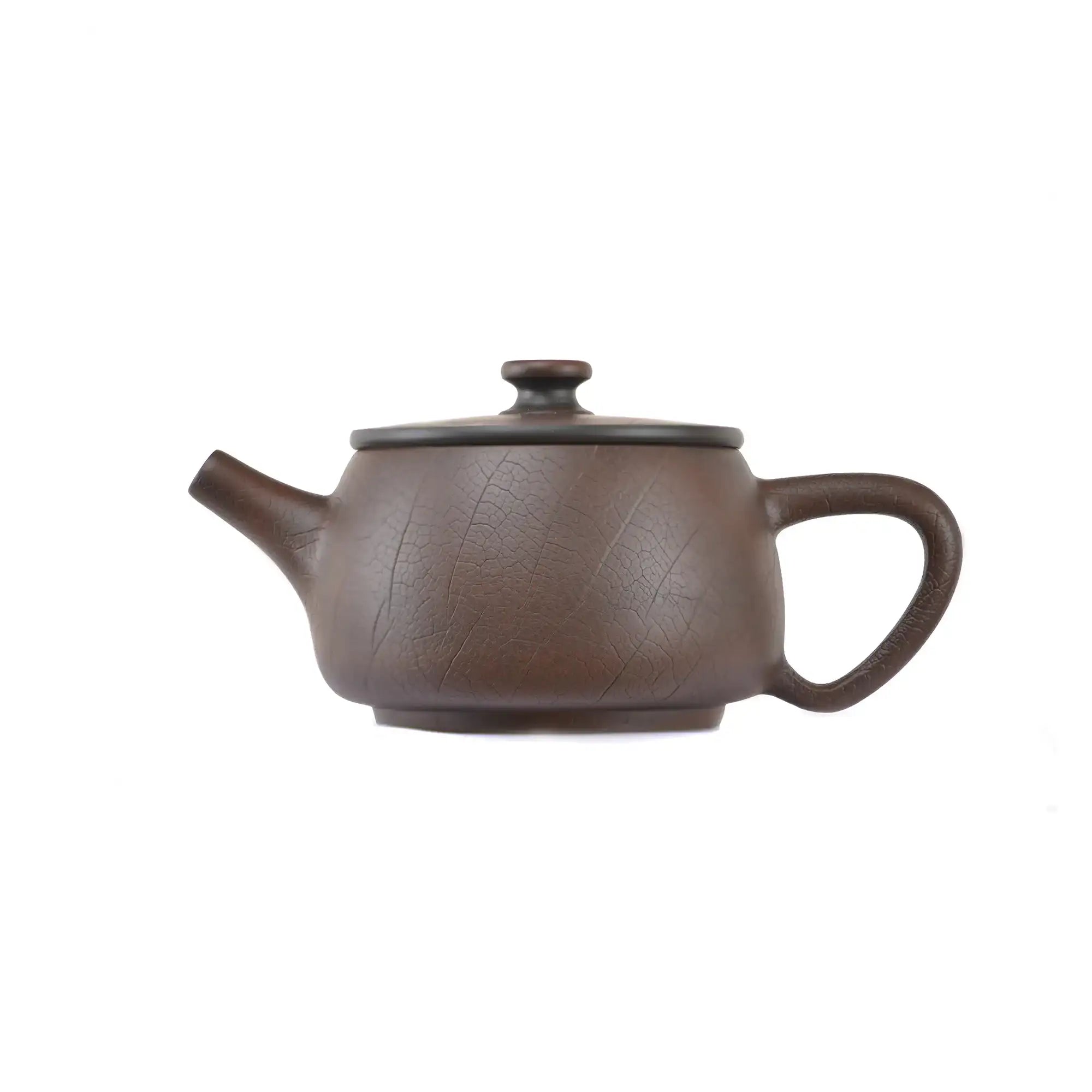 Side view of clay teapot No.22 with smooth uncarved surface and traditional form