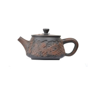 Left side view of PorSva No.34 Shipiao phoenix clay teapot highlighting detailed hand-carved feather texture