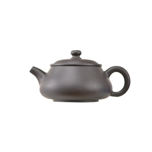 Side view of handcrafted clay teapot No.4 with smooth uncarved surface