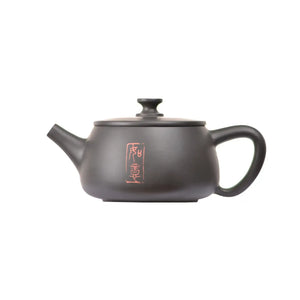 Left side view of PorSva No.41 Hanwa  clay teapot featuring carved Chinese calligraphy with red seal stamp