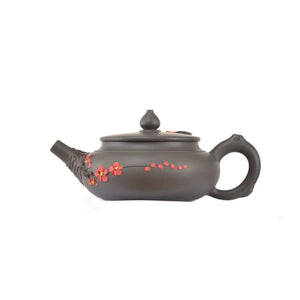 Side view of clay teapot No.19 showing plum blossom root-art design and traditional form