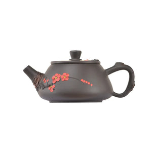 Side view of clay teapot No.20 showing plum blossom root-art design