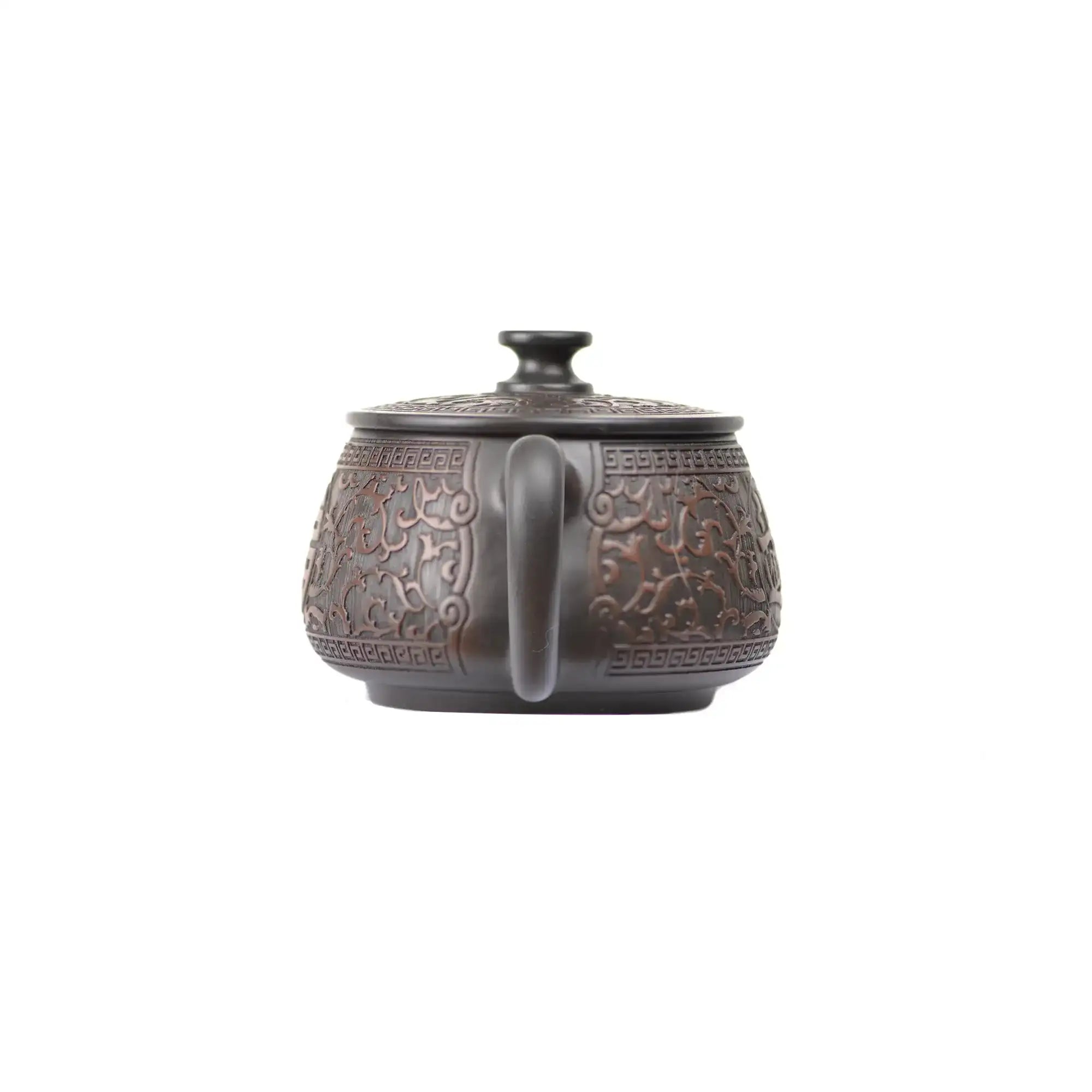 Back view of PorSva No.36 Hanwa clay teapot highlighting smooth clay surface and carved motif