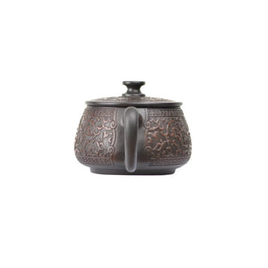 Back view of PorSva No.36 Hanwa clay teapot highlighting smooth clay surface and carved motif