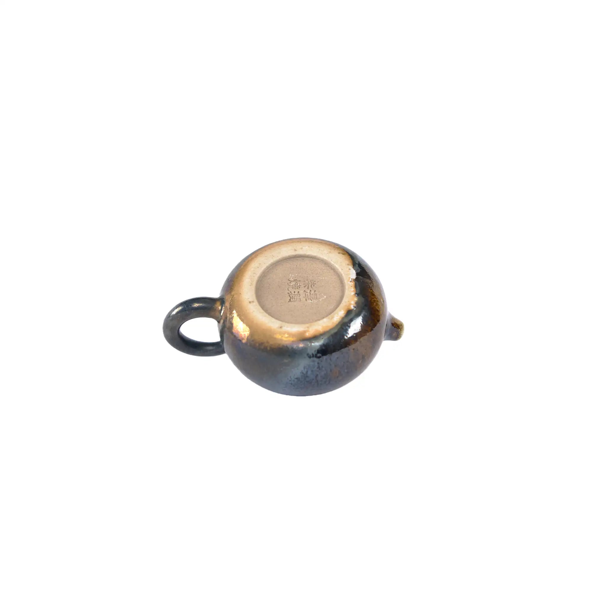 Bottom view of PorSva No.60 wood-fired clay teapot displaying natural kiln marks