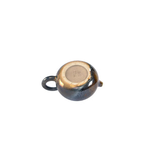 Bottom view of PorSva No.60 wood-fired clay teapot displaying natural kiln marks