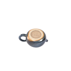 Bottom view of PorSva No.61 wood-fired Jianshui clay teapot displaying natural kiln marks