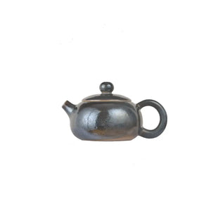 Left side view of PorSva No.61 wood-fired clay teapot with natural ash firing effects