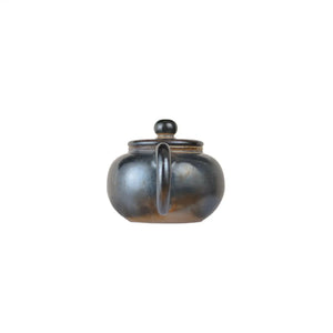 Back view of PorSva No.62 wood-fired clay teapot showing natural firing variations