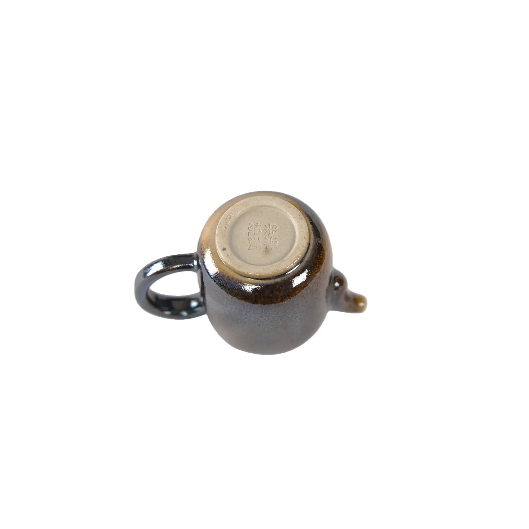 Bottom view of PorSva No.66 wood-fired clay teapot displaying natural kiln marks