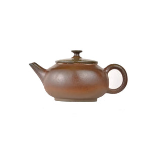 Left side view of PorSva No.45 wood-fired clay teapot showing natural kiln ash texture