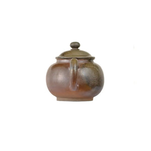 Back view of PorSva No.46 wood-fired clay teapot displaying natural kiln transformation