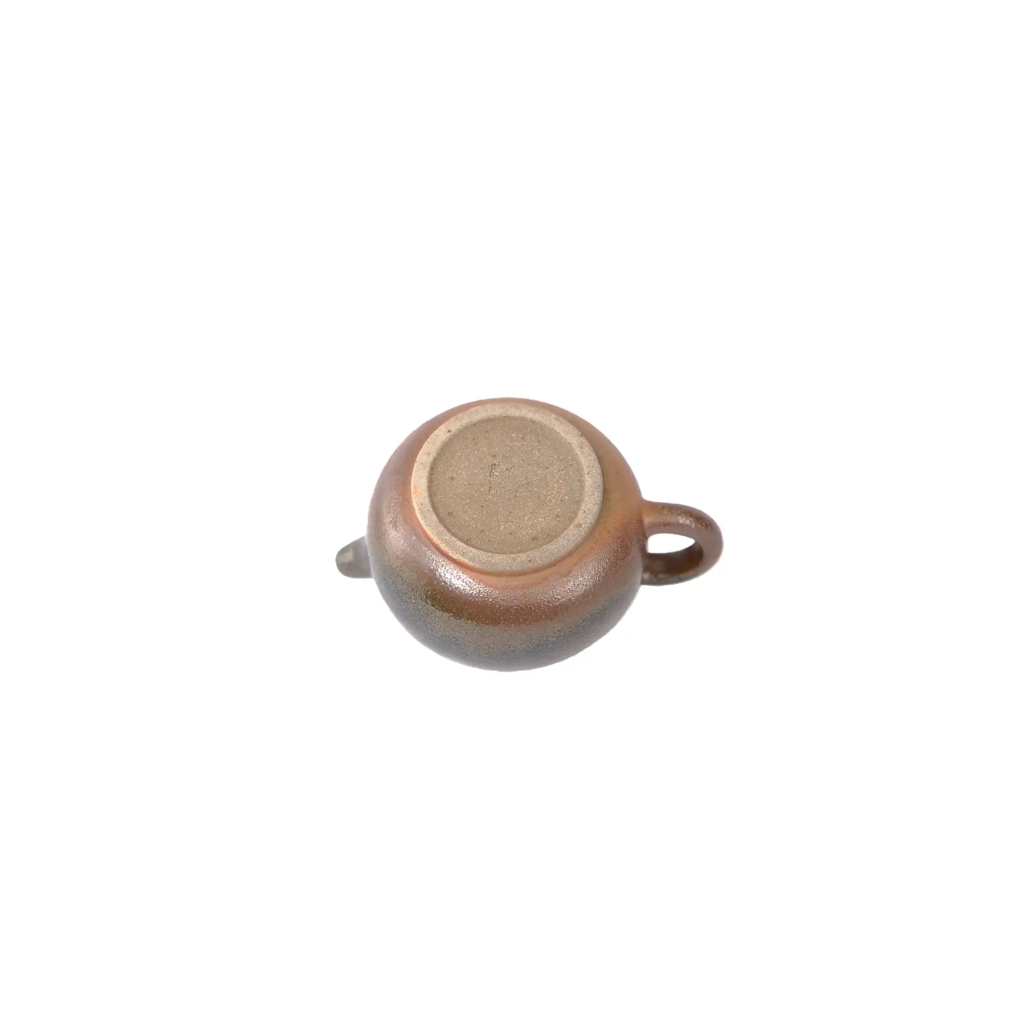 Bottom view of PorSva No.46 wood-fired clay teapot showing natural kiln marks
