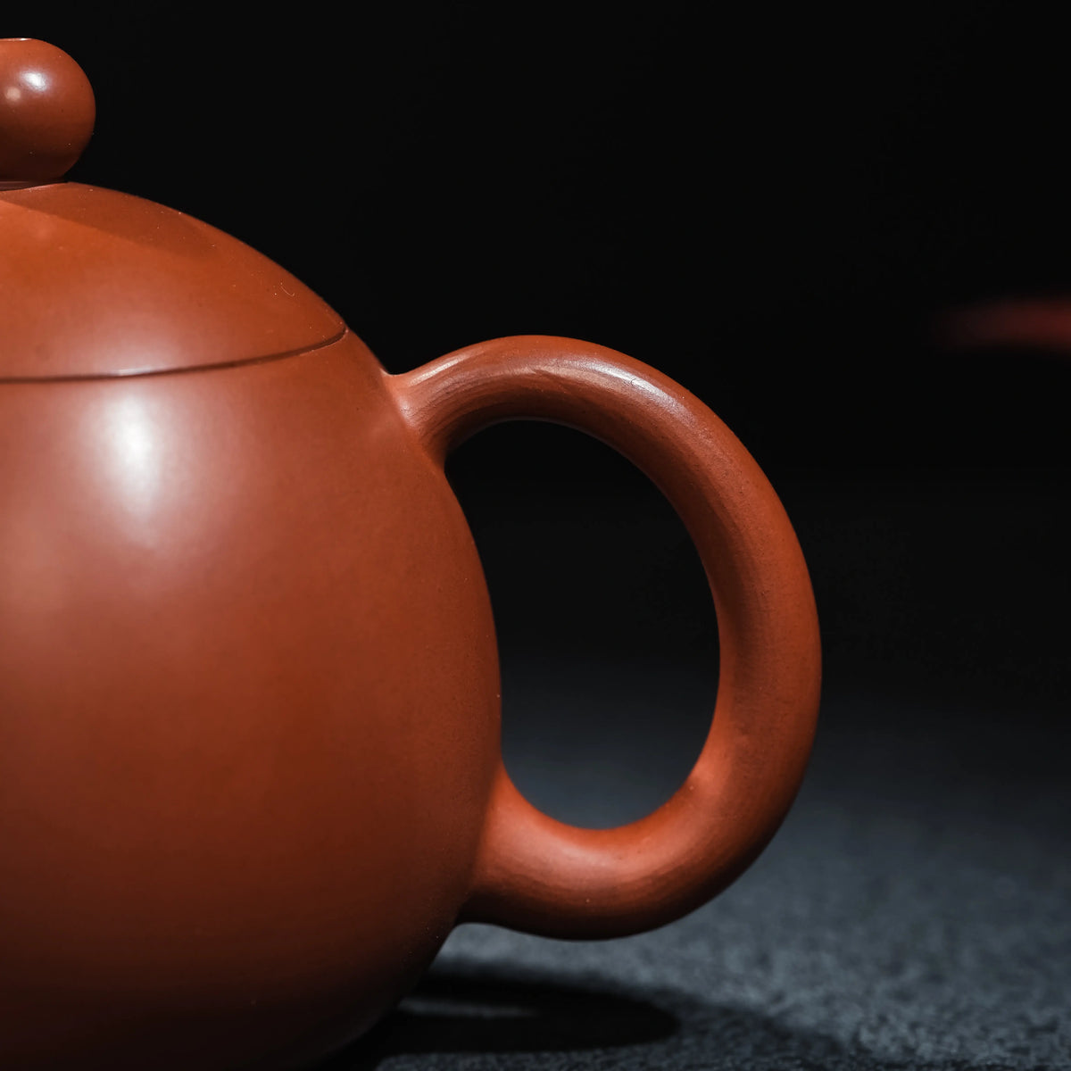 Curved handle detail of Jianshui Dragon Egg teapot