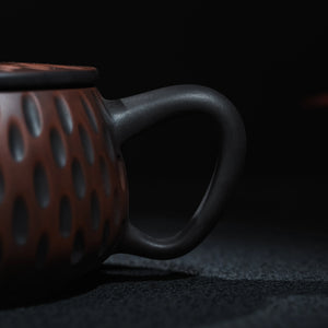Side view of Jianshui Han Tile teapot with carved texture