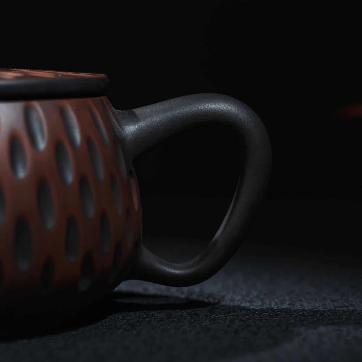 Side view of Jianshui Han Tile teapot with carved texture