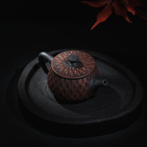 Angled view of Jianshui Meteor Carved Han Tile teapot