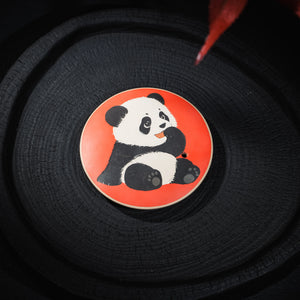 Top view of carved and clay-inlaid panda motif on Jianshui teapot lid