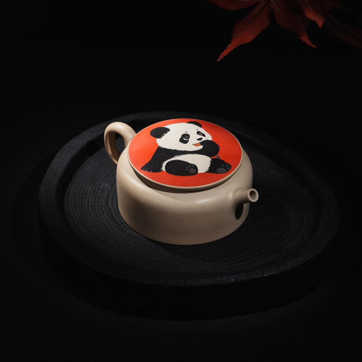 Angled view of Jianshui teapot with panda inlay lid