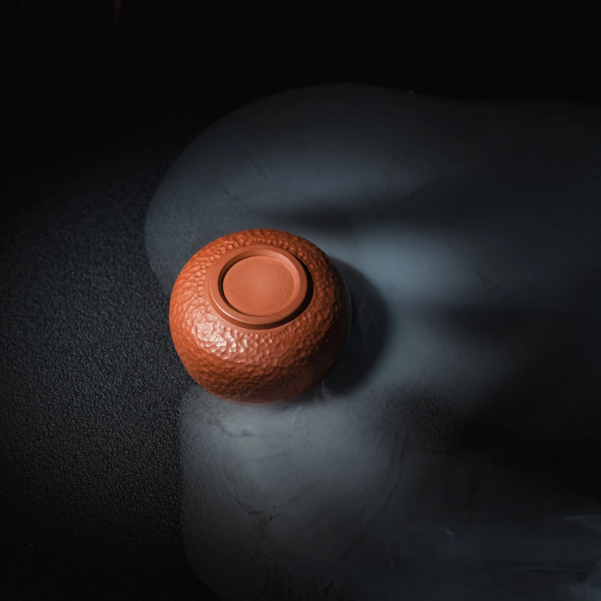 Bottom view of handmade Jianshui red clay tea cup