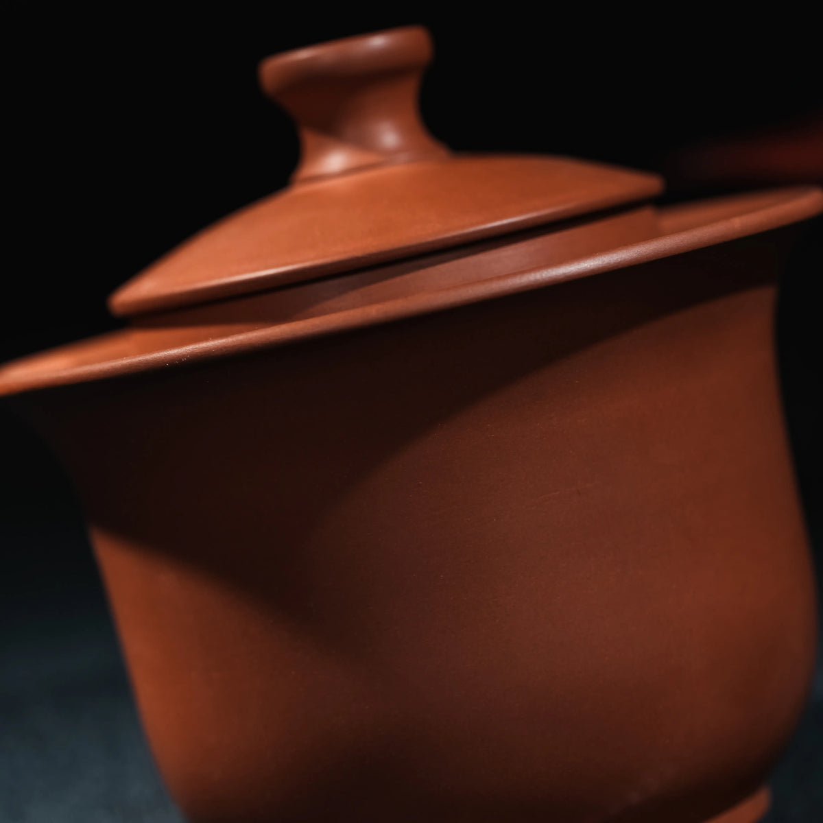 Close view of smooth unglazed Jianshui red clay teapot