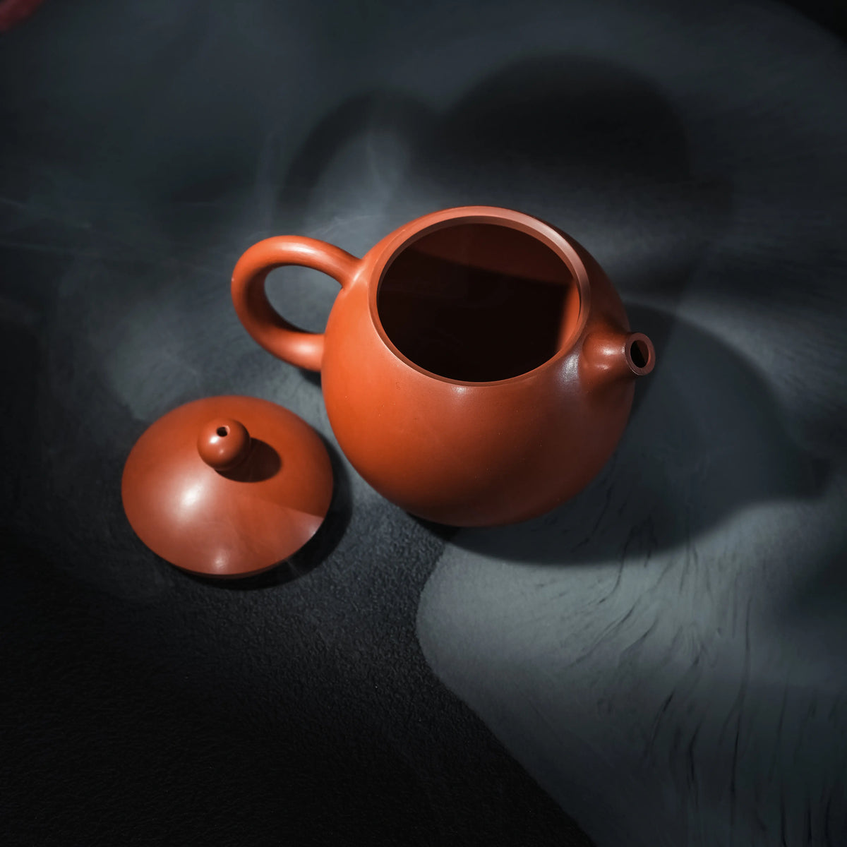 Jianshui red clay teapot with lid removed showing the opening