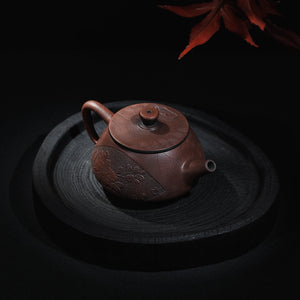 Angled view of Jianshui Shi Piao teapot with relief decoration