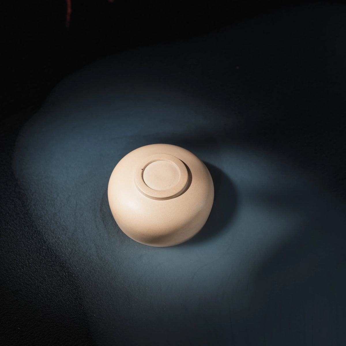 Bottom view of handmade Jianshui white clay tea cup