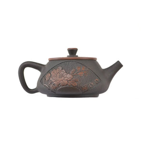 Side view of clay teapot No.23 showing Bodhi pattern texture and peony relief design