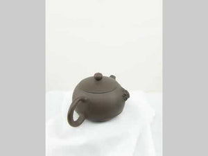 Back view of handcrafted clay teapot No.21 featuring Bodhi pattern and relief details