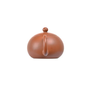 Back view of PorSva No.50 plain red clay teapot emphasizing natural clay surface