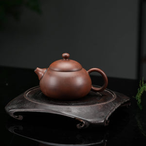 Jianshui red clay teapot displayed in a gongfu tea setting
